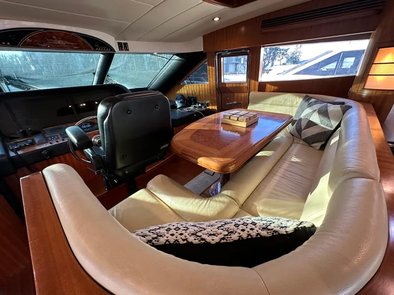 Slide: The Image of Luxurious interior of 2007 Horizon 73 Motor Yacht with leather seating and wooden table. - 35