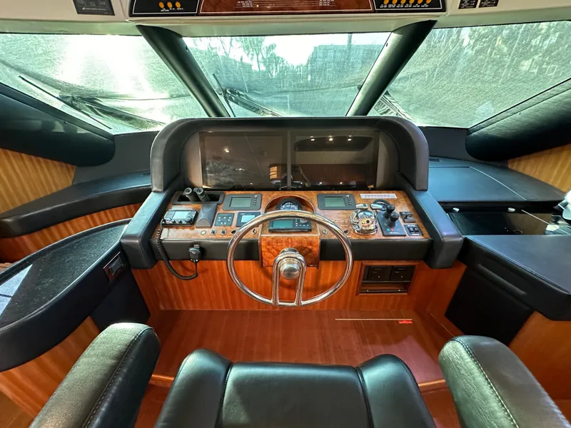 Slide: The Image of Cockpit of 2007 Horizon 73 Motor Yacht with modern navigation equipment and wooden dashboard. - 38