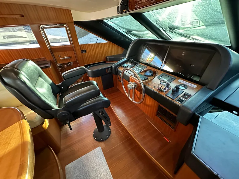 Slide: The Image of Luxurious 2007 Horizon 73 Motor Yacht helm with leather captain's chair and advanced navigation controls. - 40