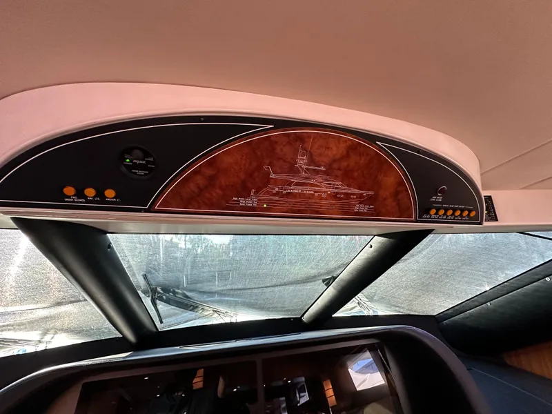 Slide: The Image of Interior dashboard of a 2007 Horizon 73 Motor Yacht with wood paneling and controls. - 44