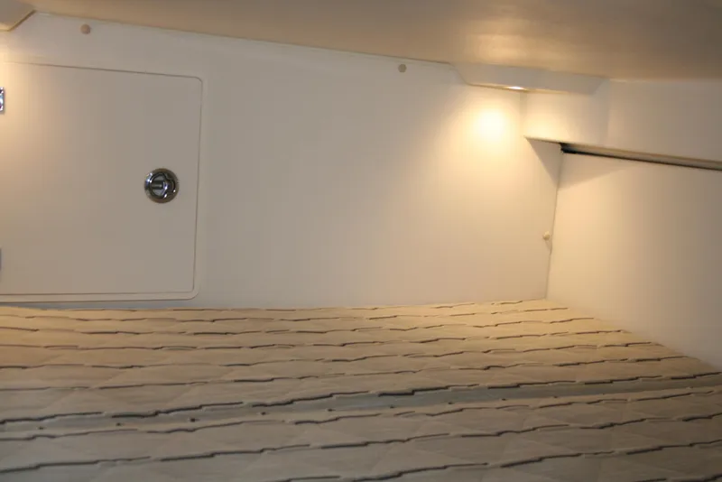 Slide: The Image of 2021 Pursuit OS 325 Offshore cabin interior with lighting and storage compartment. - 17