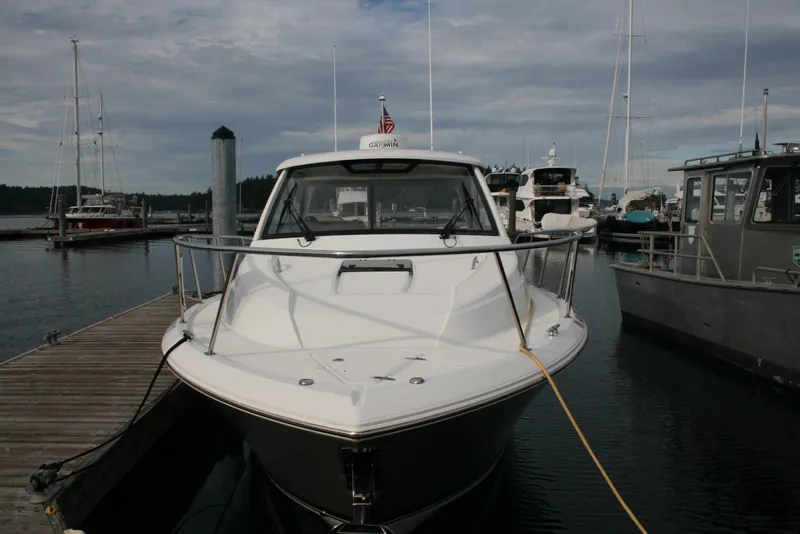 Slide: The Image of 2021 Pursuit OS 325 Offshore boat docked at marina, front view. - 2