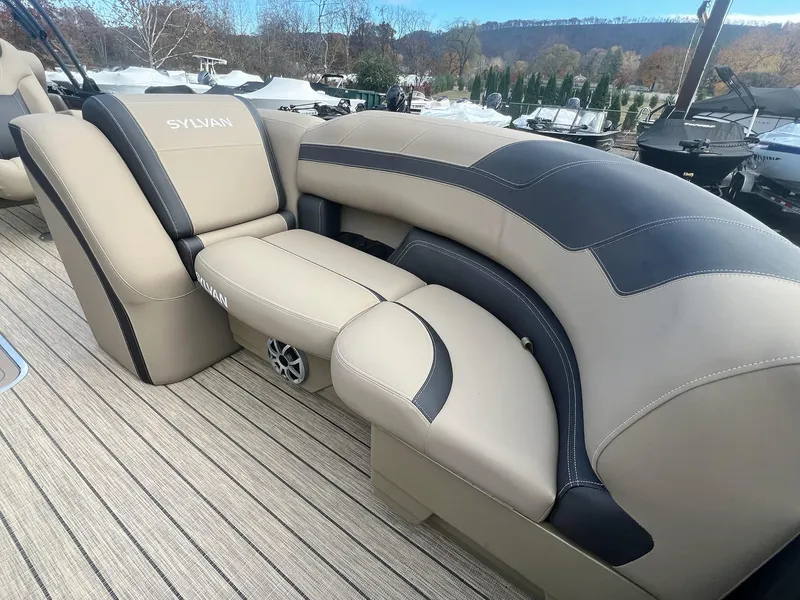 Slide: The Image of Luxurious seating on 2025 Sylvan L3 DLZ Tritoon boat, featuring beige and black upholstery. - 14