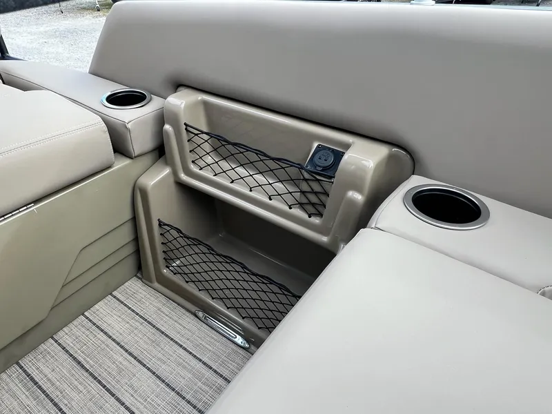 Slide: The Image of 2025 Sylvan L3 DLZ Tritoon interior with cup holders and storage compartments. - 22