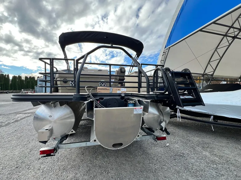 Slide: The Image of 2025 Sylvan L3 DLZ Tritoon boat rear view with ladder and canopy. - 26