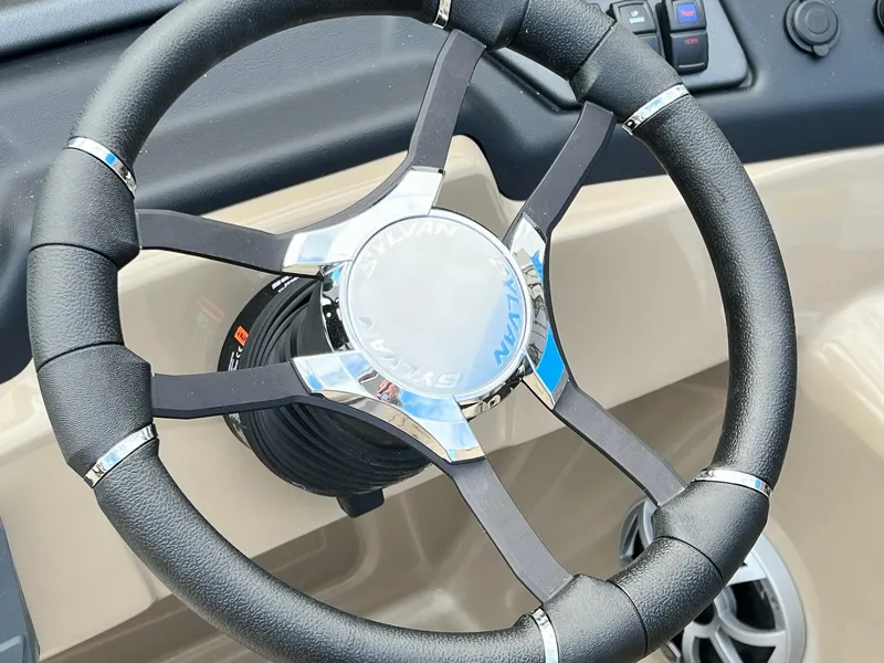 Slide: The Image of Steering wheel of 2025 Sylvan L3 DLZ Tritoon boat, featuring sleek design and controls. - 36