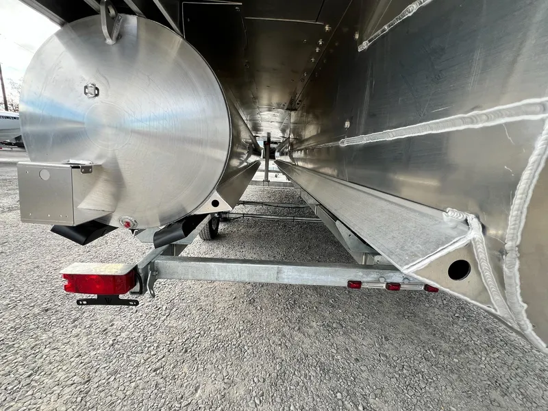 Slide: The Image of 2025 Sylvan L3 DLZ Tritoon underside view, showcasing aluminum construction and trailer attachment. - 38