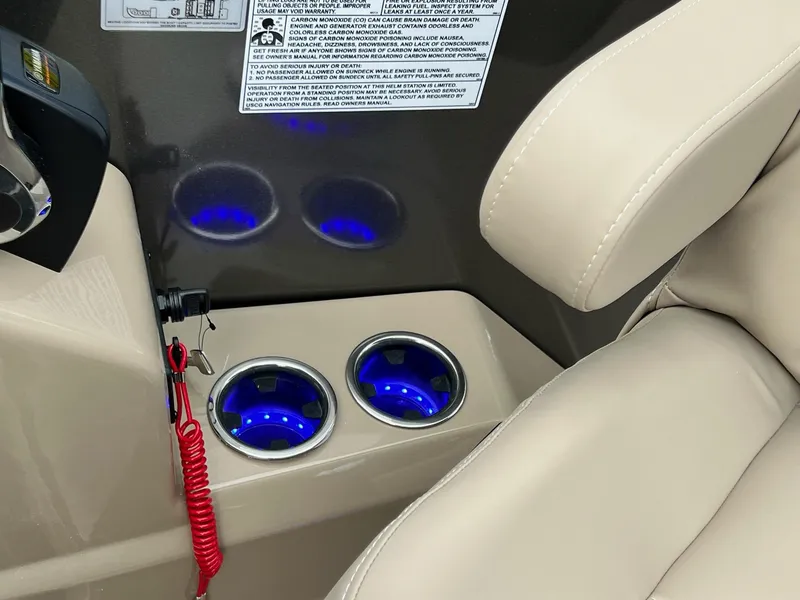 Slide: The Image of 2025 Sylvan L3 DLZ Tritoon interior with illuminated cup holders and beige seating. - 40