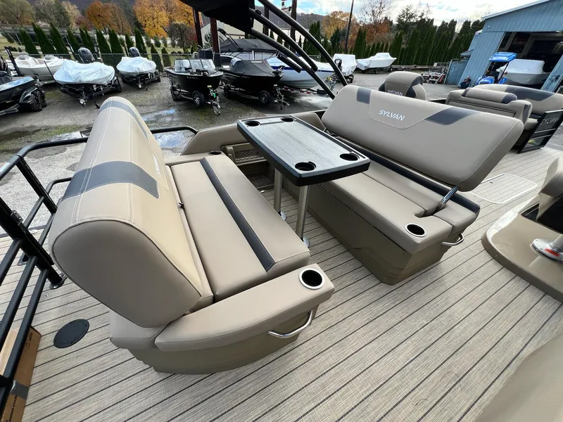 Slide: The Image of 2025 Sylvan L3 DLZ Tritoon interior with beige seating and table, showcasing luxury design. - 44