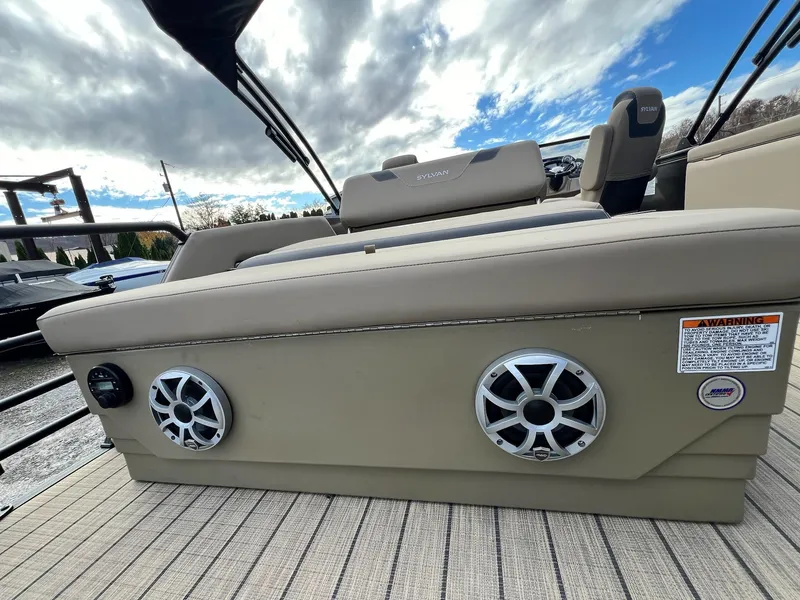 Slide: The Image of 2025 Sylvan L3 DLZ Tritoon boat with beige seating and built-in speakers. - 45
