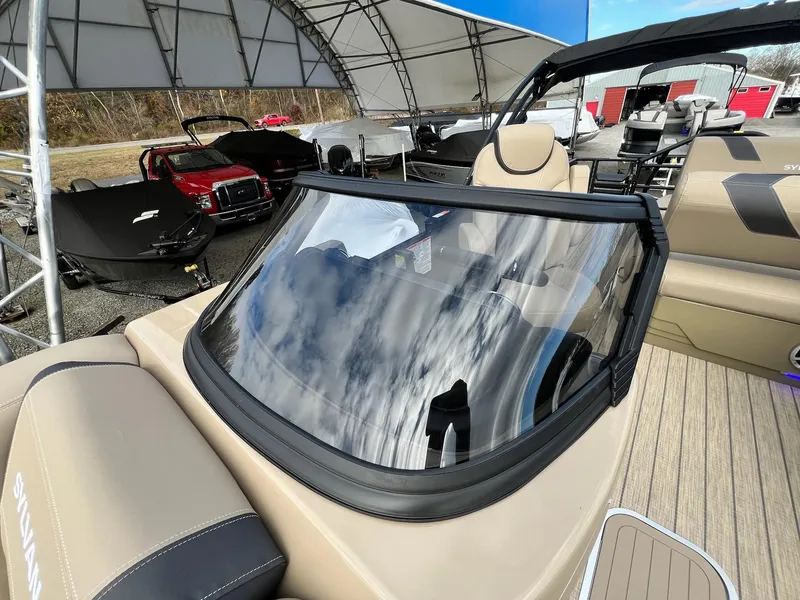 Slide: The Image of 2025 Sylvan L3 DLZ Tritoon boat with sleek windshield and luxurious seating. - 5