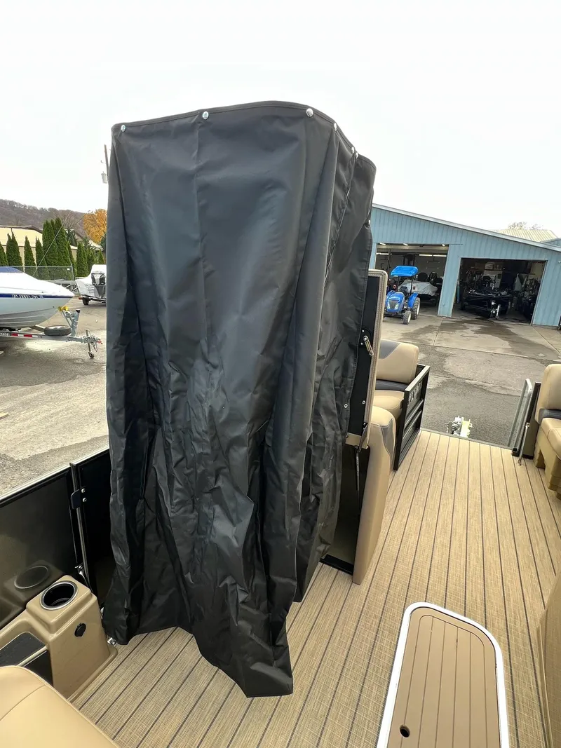 Slide: The Image of 2025 Sylvan L3 DLZ Tritoon with black privacy curtain on deck. - 6