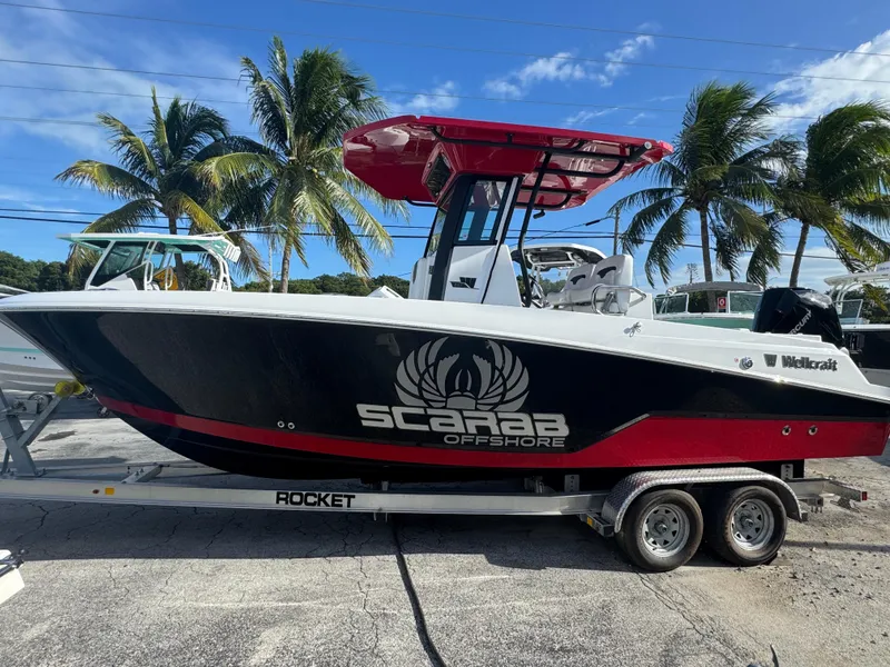 The Image of 2025 Wellcraft 243 Fisherman boat on trailer, palm trees in background. - 1
