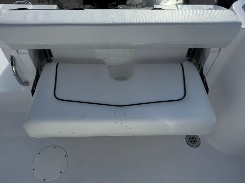 Slide: The Image of 2025 Wellcraft 243 Fisherman boat seat with white upholstery and black trim. - 10