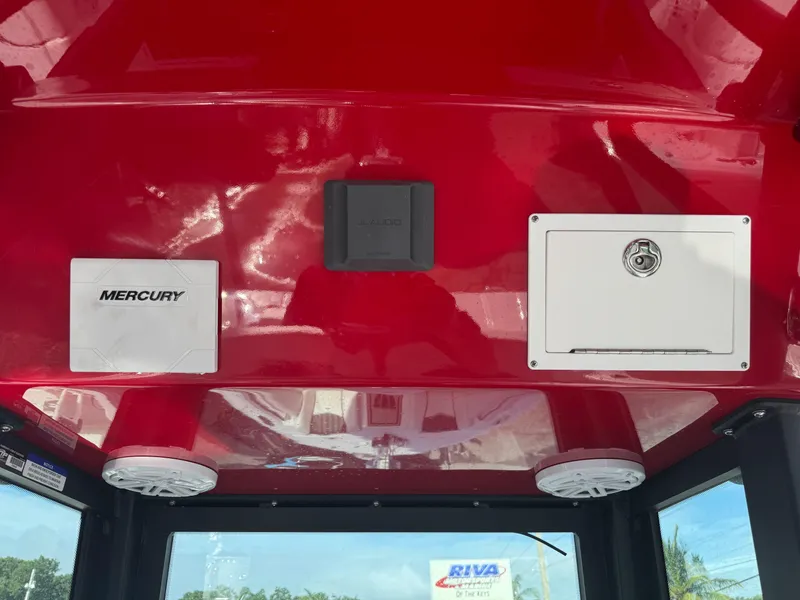 Slide: The Image of Red interior of 2025 Wellcraft 243 Fisherman boat with Mercury panel and speakers. - 14