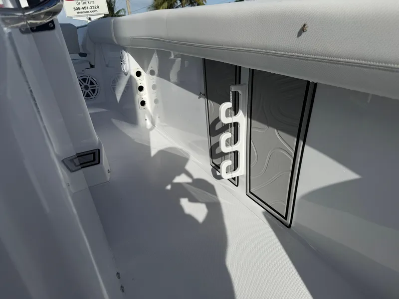 Slide: The Image of Interior view of 2025 Wellcraft 243 Fisherman boat, featuring rod holders and seating. - 15