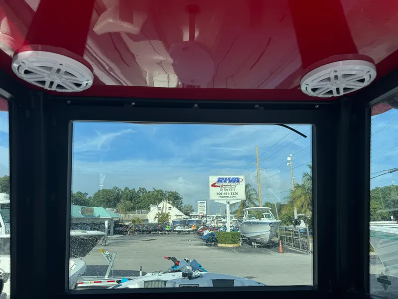 Slide: The Image of View from 2025 Wellcraft 243 Fisherman boat, showcasing marina and dealership sign. - 17