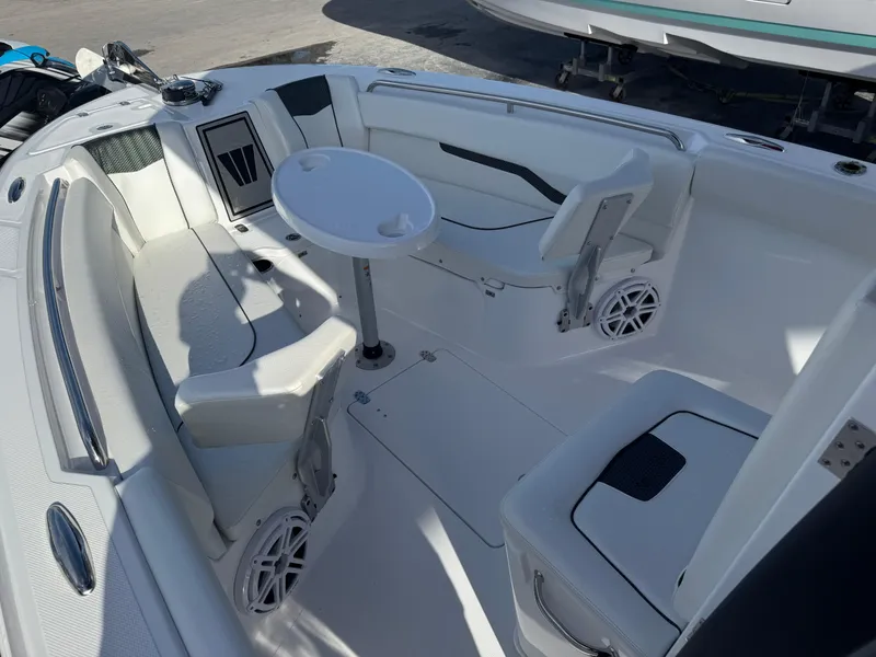 Slide: The Image of 2025 Wellcraft 243 Fisherman boat interior with seating and table. - 22