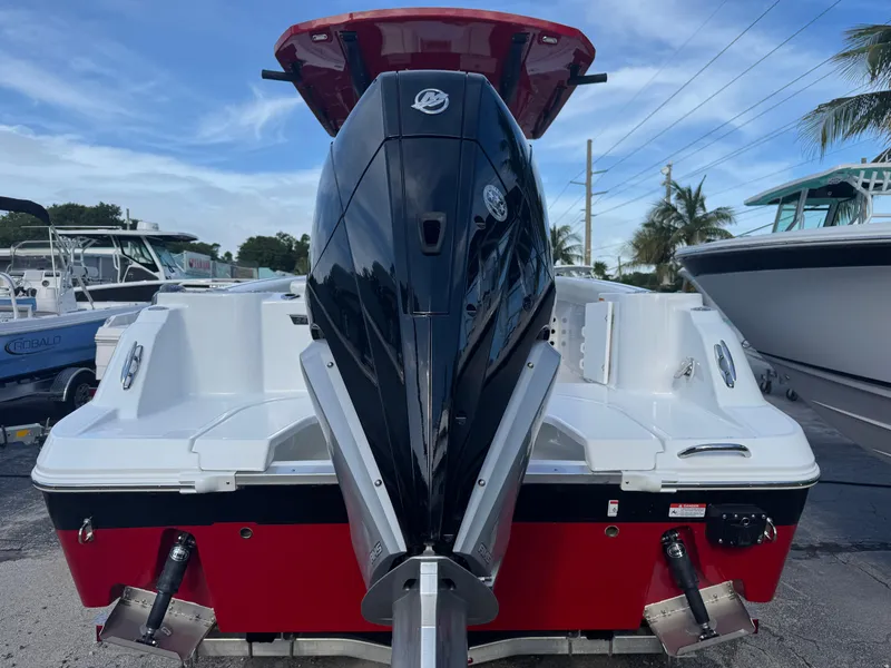 Slide: The Image of 2025 Wellcraft 243 Fisherman boat with powerful outboard motor, red and white design. - 3