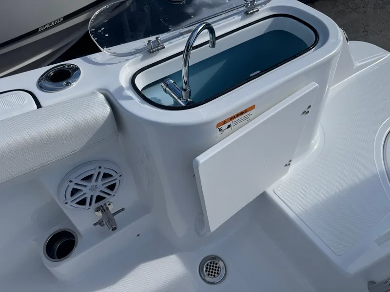 Slide: The Image of 2025 Wellcraft 243 Fisherman boat interior with sink and storage compartment. - 9