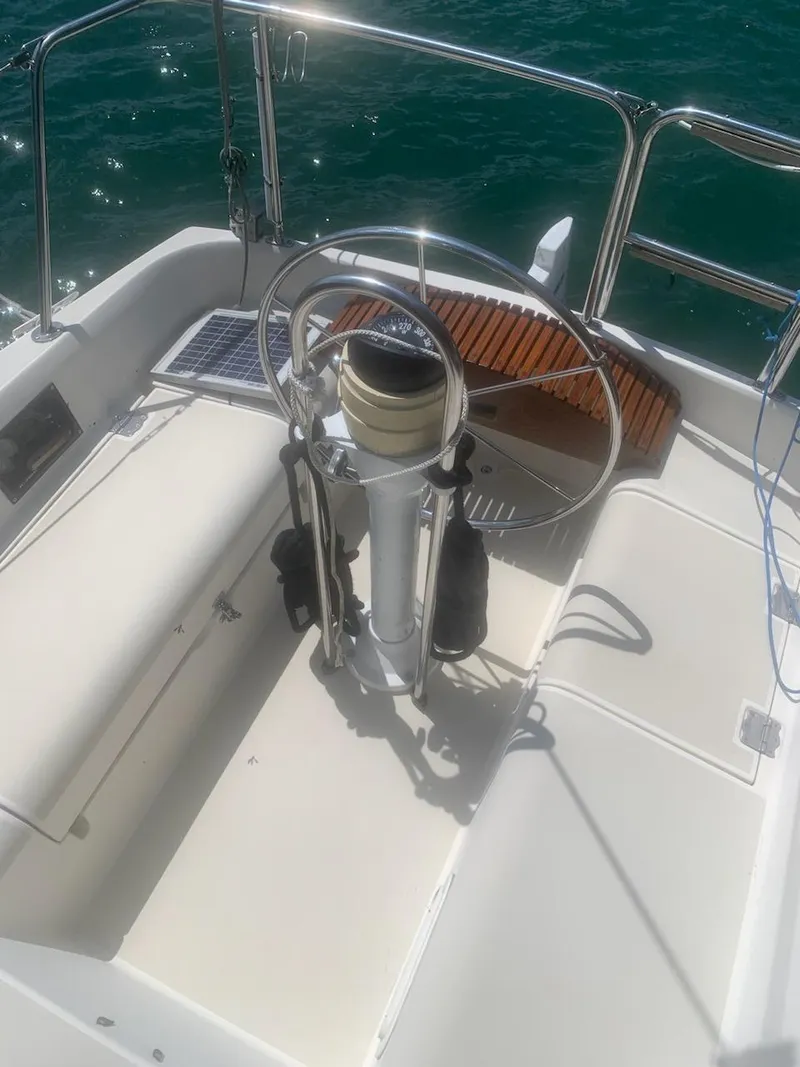 Slide: The Image of Steering wheel of a 1990 Pearson 27 sailboat on a sunny day. - 6