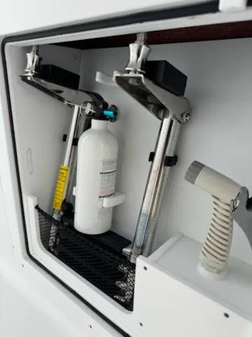 Slide: The Image of 2024 Crevalle 33 CSF boat storage compartment with safety equipment. - 20