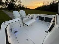 Slide: The Image of 2024 Crevalle 33 CSF boat deck at sunset, featuring dual engines and spacious seating. - 28