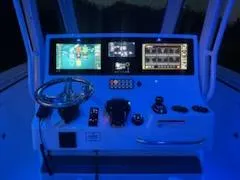 Slide: The Image of 2024 Crevalle 33 CSF boat dashboard with illuminated controls and navigation screens. - 3
