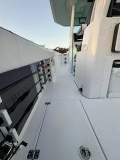 Slide: The Image of 2024 Crevalle 33 CSF boat deck with sleek white design and modern features. - 30