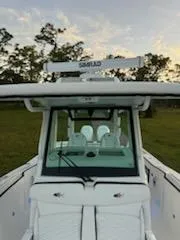 Slide: The Image of 2024 Crevalle 33 CSF boat with radar, front view at sunset. - 35