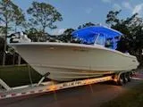 Slide: The Image of 2024 Crevalle 33 CSF boat on trailer with blue canopy, parked outdoors. - 38