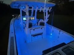 Slide: The Image of 2024 Crevalle 33 CSF boat with blue interior lighting at night. - 41