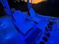 Slide: The Image of 2024 Crevalle 33 CSF boat interior with blue LED lighting at sunset. - 43