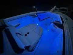 Slide: The Image of 2024 Crevalle 33 CSF boat interior with blue LED lighting. - 44