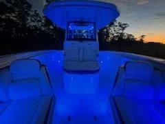 Slide: The Image of 2024 Crevalle 33 CSF boat with blue LED interior lighting at dusk. - 46