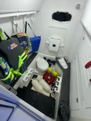 Slide: The Image of 2024 Crevalle 33 CSF boat interior with storage, life jackets, and safety equipment. - 47