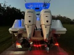 Slide: The Image of 2024 Crevalle 33 CSF boat with dual 350 engines, illuminated at dusk. - 6