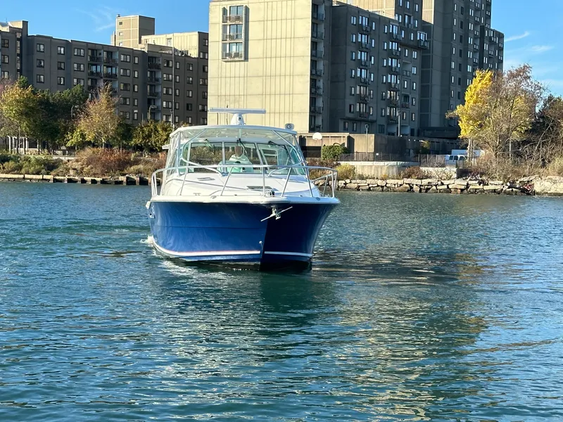 Slide: The Image of 2011 Rampage 34 IPS boat on water near urban buildings. - 10