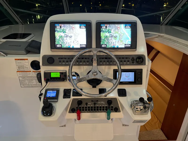 Slide: The Image of 2011 Rampage 34 IPS boat helm with dual navigation screens and control panel. - 16