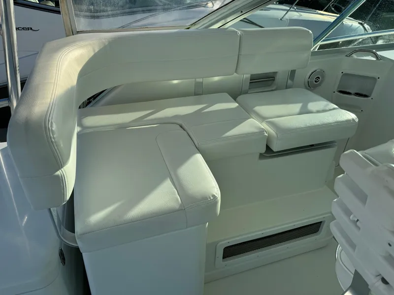 Slide: The Image of White seating area on 2011 Rampage 34 IPS boat, featuring cushioned seats and modern design. - 19