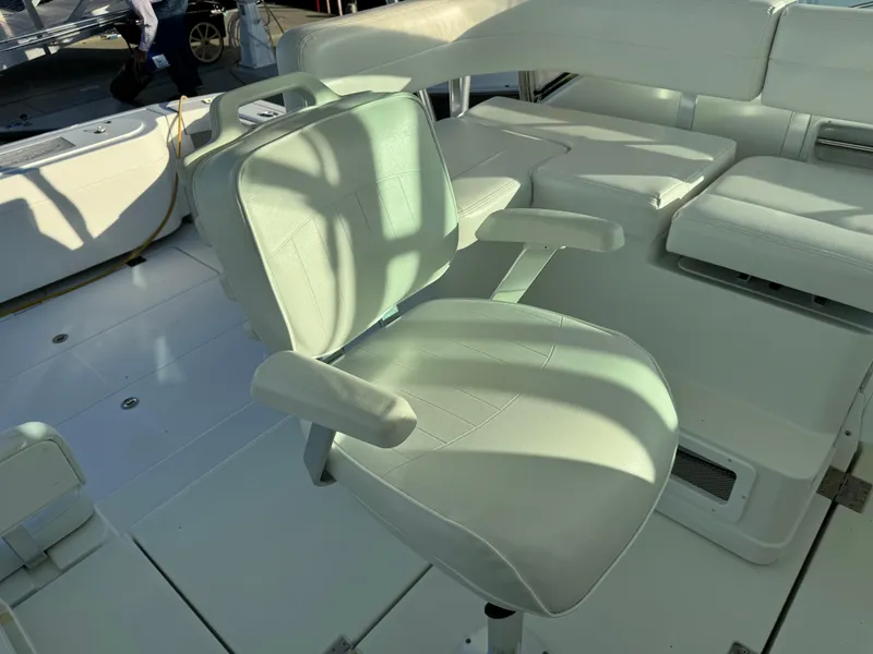 Slide: The Image of 2011 Rampage 34 IPS boat interior with white seating and armrests. - 20