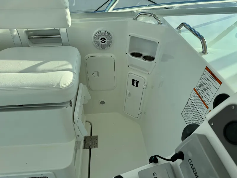 Slide: The Image of Interior of 2011 Rampage 34 IPS boat with white seating and control panel. - 21