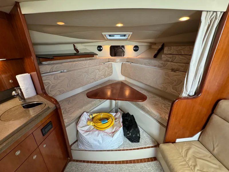 Slide: The Image of Interior of 2011 Rampage 34 IPS boat with cozy seating and kitchenette. - 29