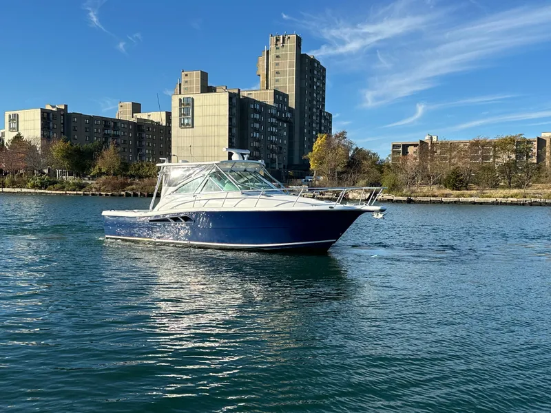 Slide: The Image of 2011 Rampage 34 IPS boat on urban waterfront with buildings in background. - 3