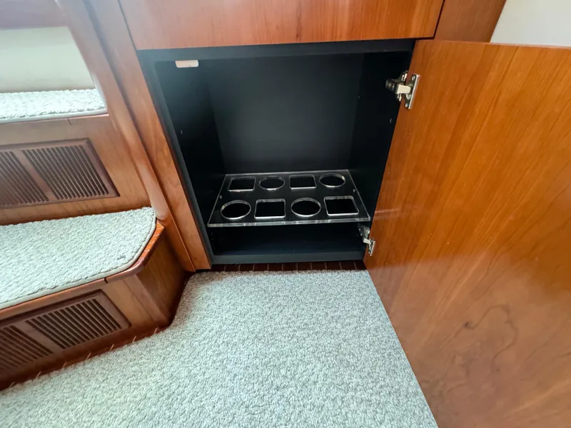 Slide: The Image of Open cabinet with cup holders on a 2011 Rampage 34 IPS boat. - 33