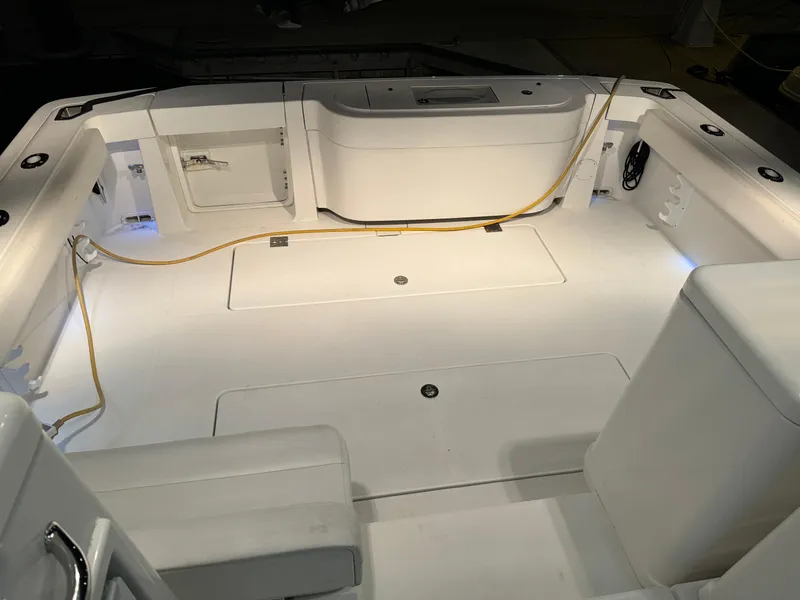 Slide: The Image of 2011 Rampage 34 IPS boat interior with white seating and storage compartments. - 39