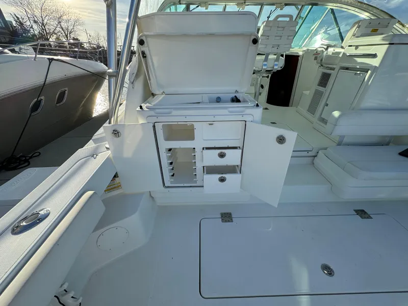 Slide: The Image of 2011 Rampage 34 IPS boat interior with open storage compartments and seating area. - 46