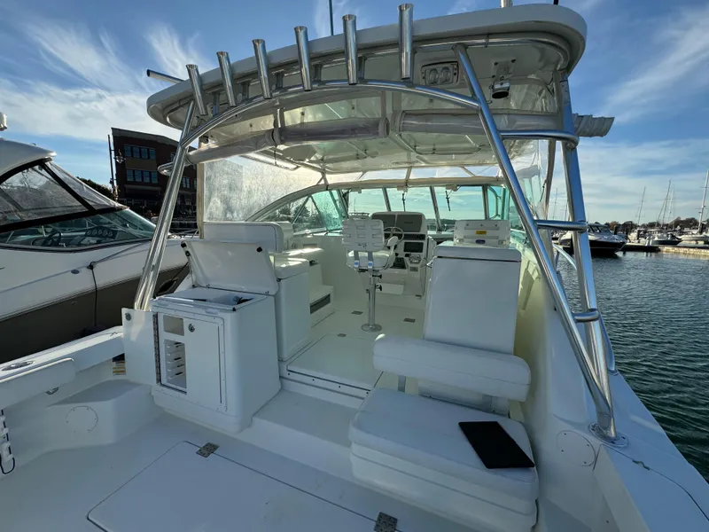 Slide: The Image of 2011 Rampage 34 IPS boat interior with seating and helm, docked at marina. - 47
