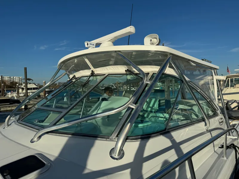 Slide: The Image of 2011 Rampage 34 IPS boat with sleek design and sturdy windshield at marina. - 49