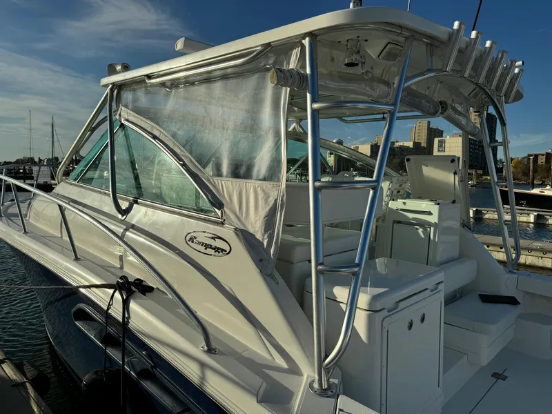 Slide: The Image of 2011 Rampage 34 IPS boat docked at marina, featuring sleek design and sturdy structure. - 50